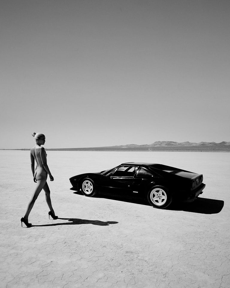 A naked woman and a black Ferrari 308.