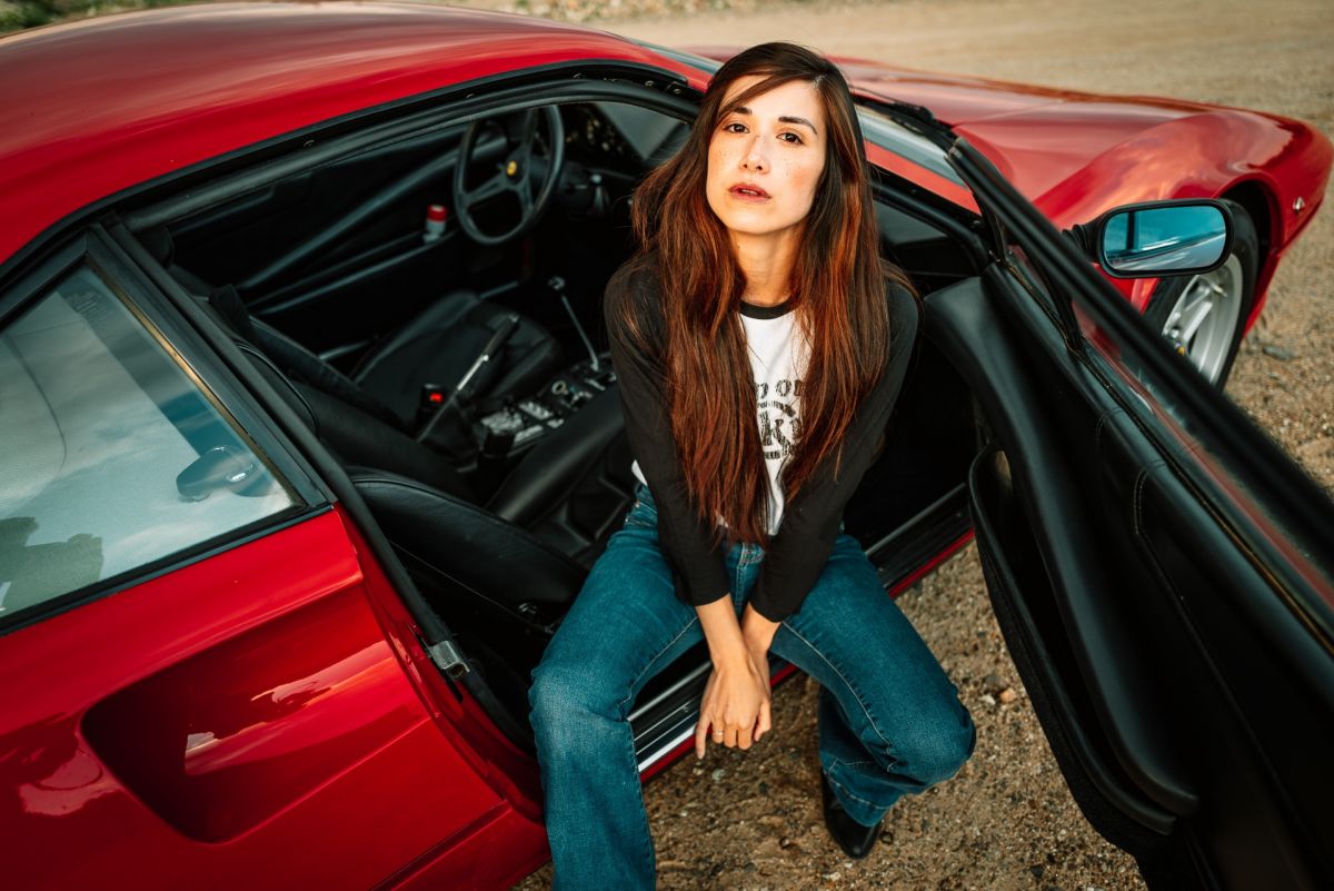 A girl and a red Ferrari 308 on July 11, 2020.