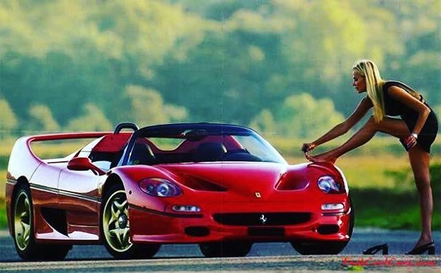 A blonde girl and a red Ferrari.