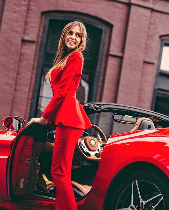 A girl and a red Ferrari.