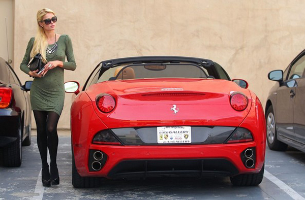 Paris Hilton with a red Ferrari California.