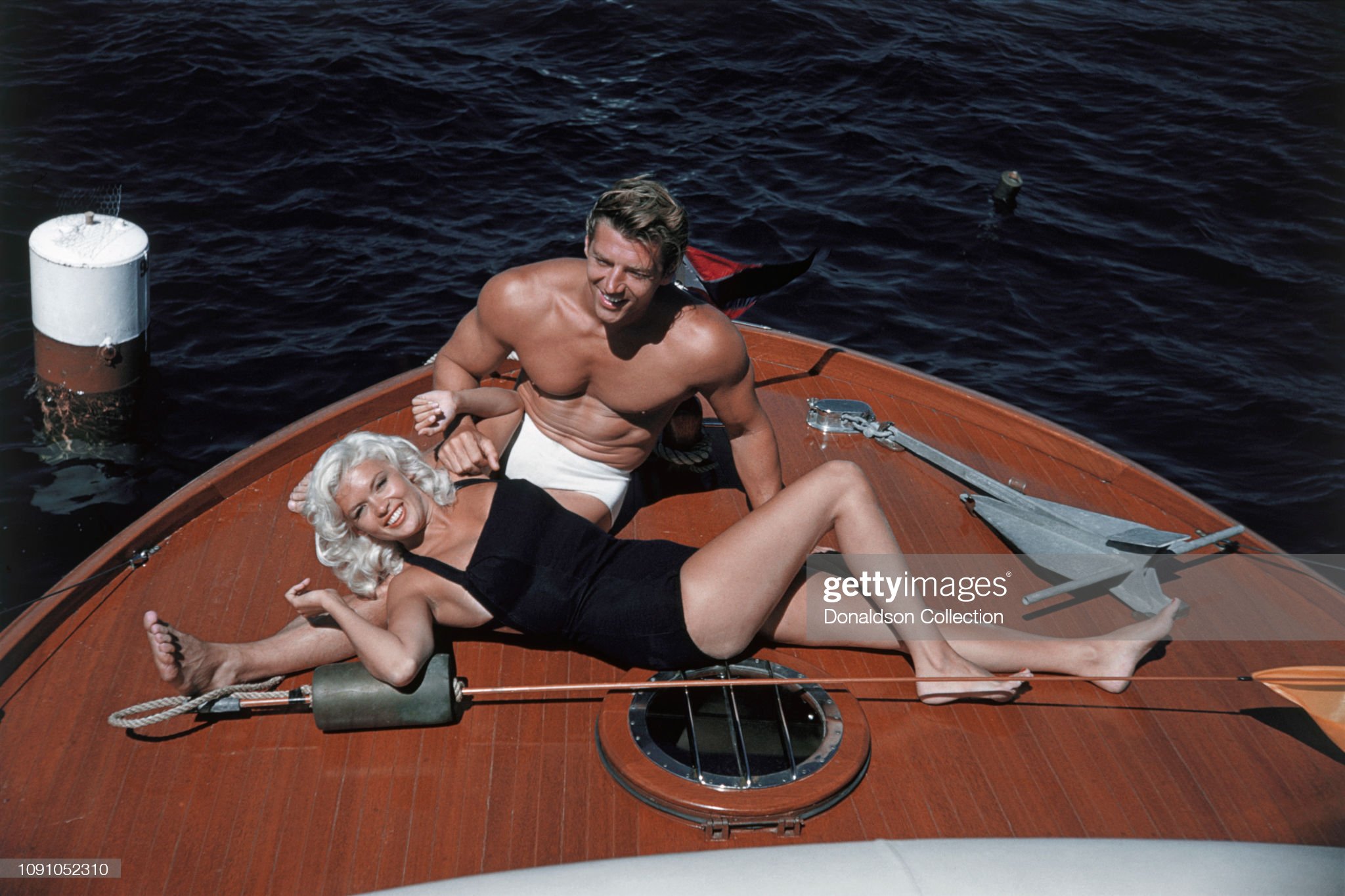 Jayne Mansfield poses for a photo with husband Mickey Hargitay on their way to Catalina on July 22, 1957 between Los Angeles and Catalina, California. 