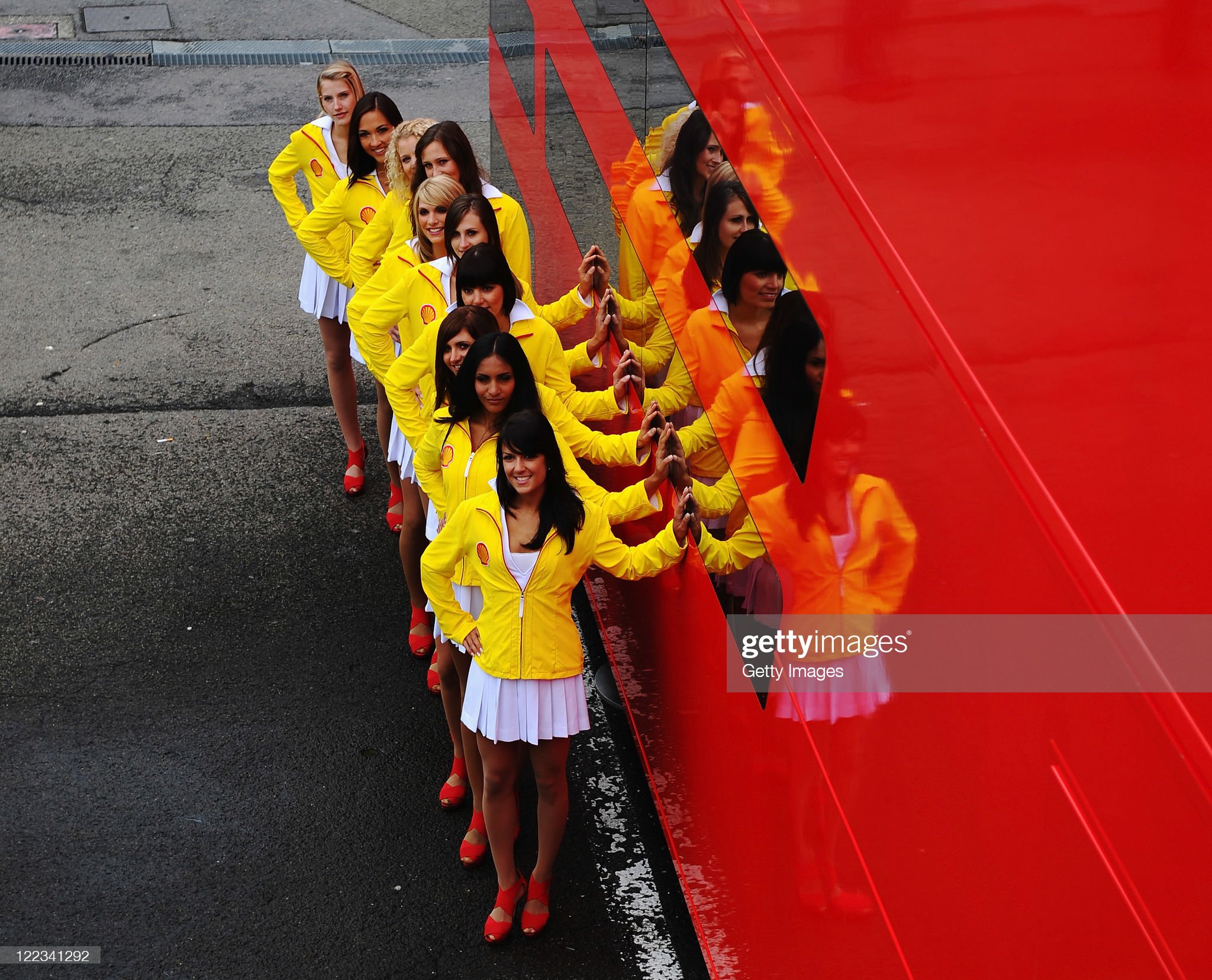 Shell grid girls pose for a photograph outside the Ferrari hospitality unit before the Belgian Formula One Grand Prix at the Circuit of Spa Francorchamps on August 28, 2011.