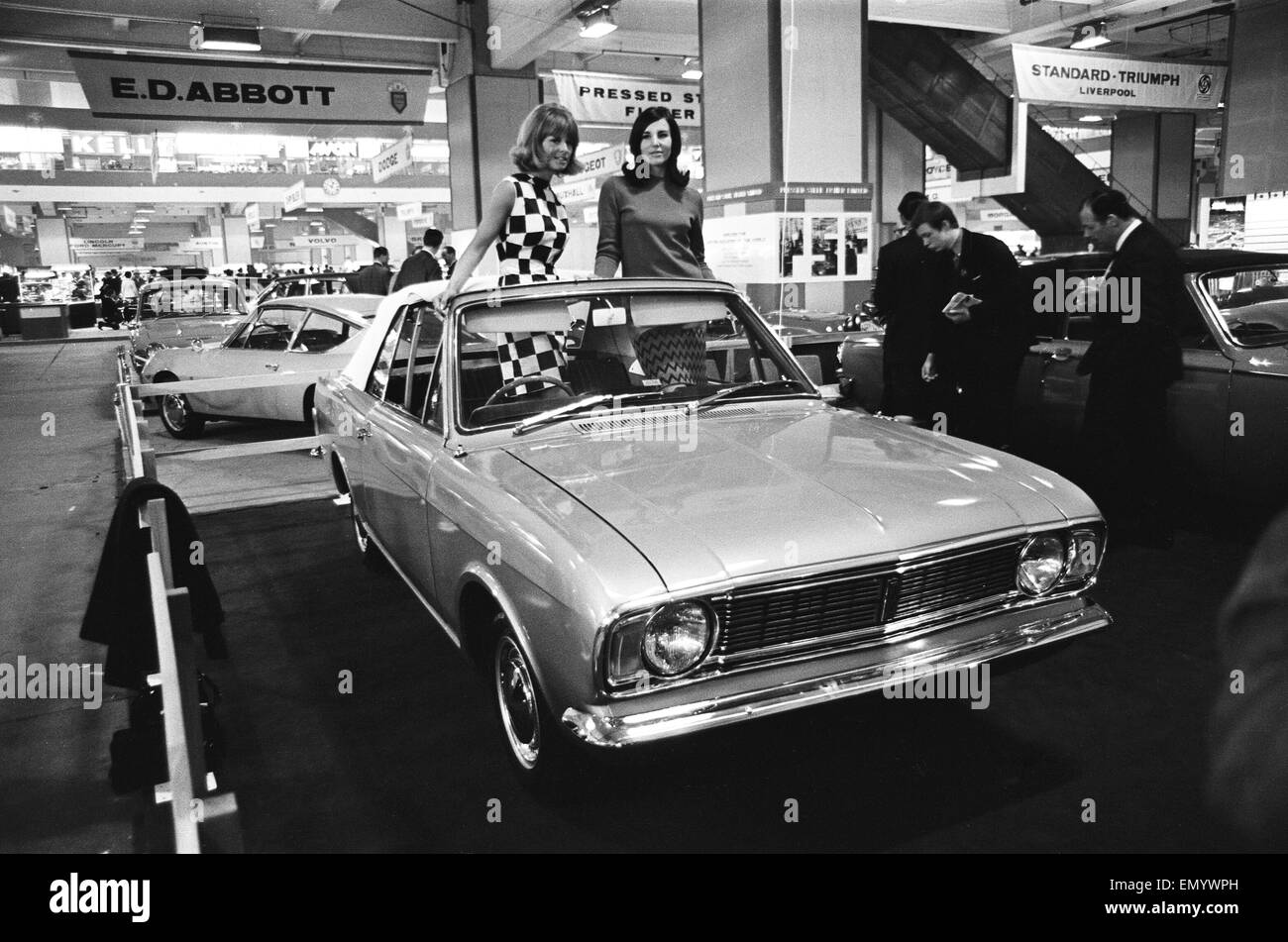 Models posing in this soft top Ford Consul at the London Motor Show on 18 October 1966.