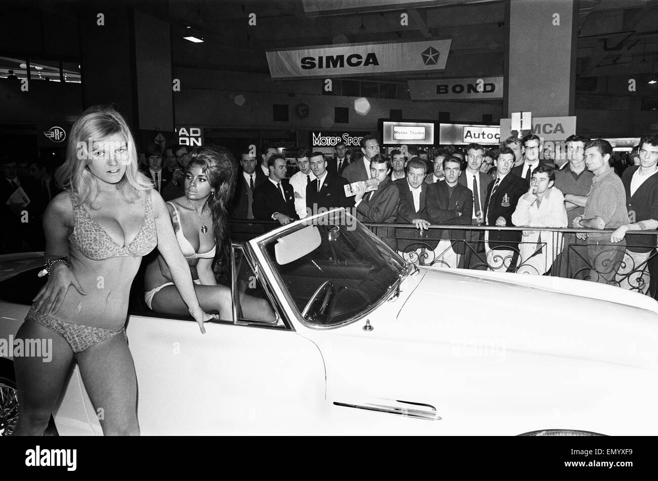 Models drapped over cars at the London Motor Show on 18 October 1966.