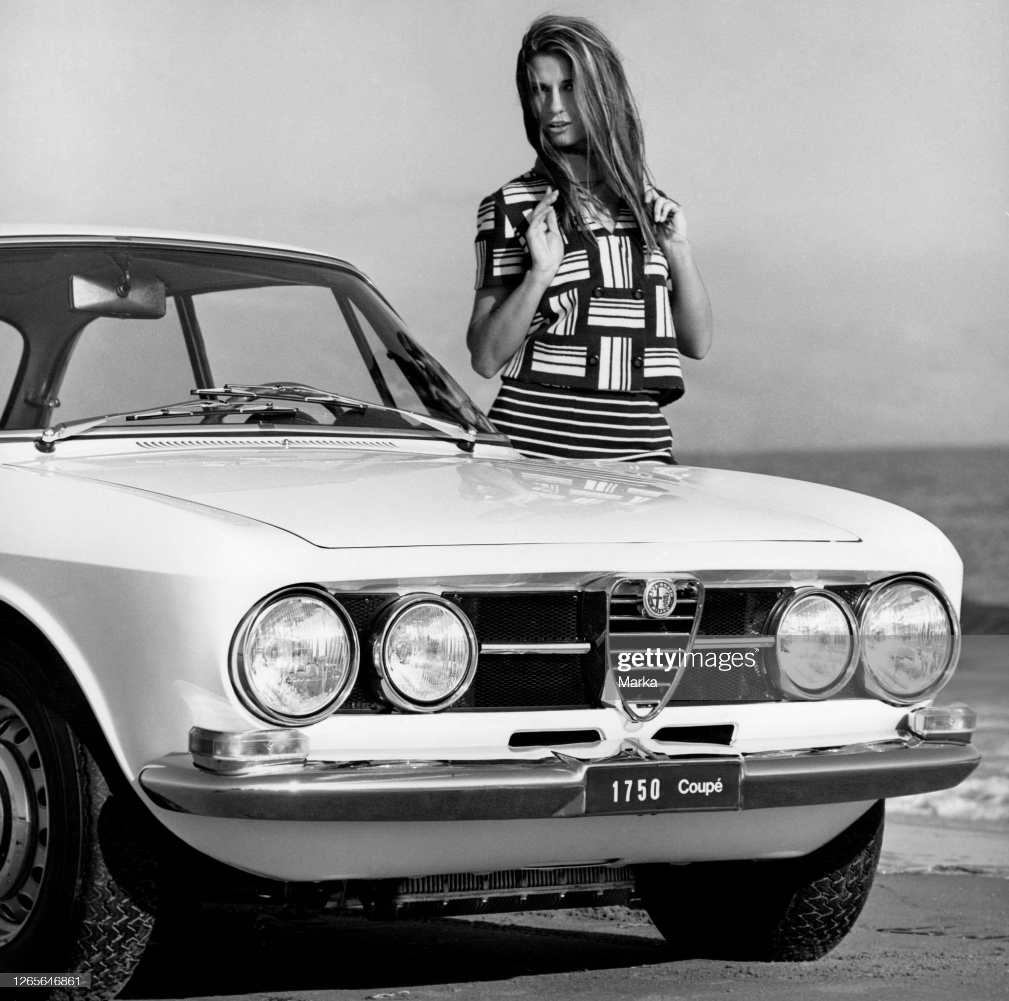 A girl in front of an Alfa Romeo 1750 Coupé in 1970. 