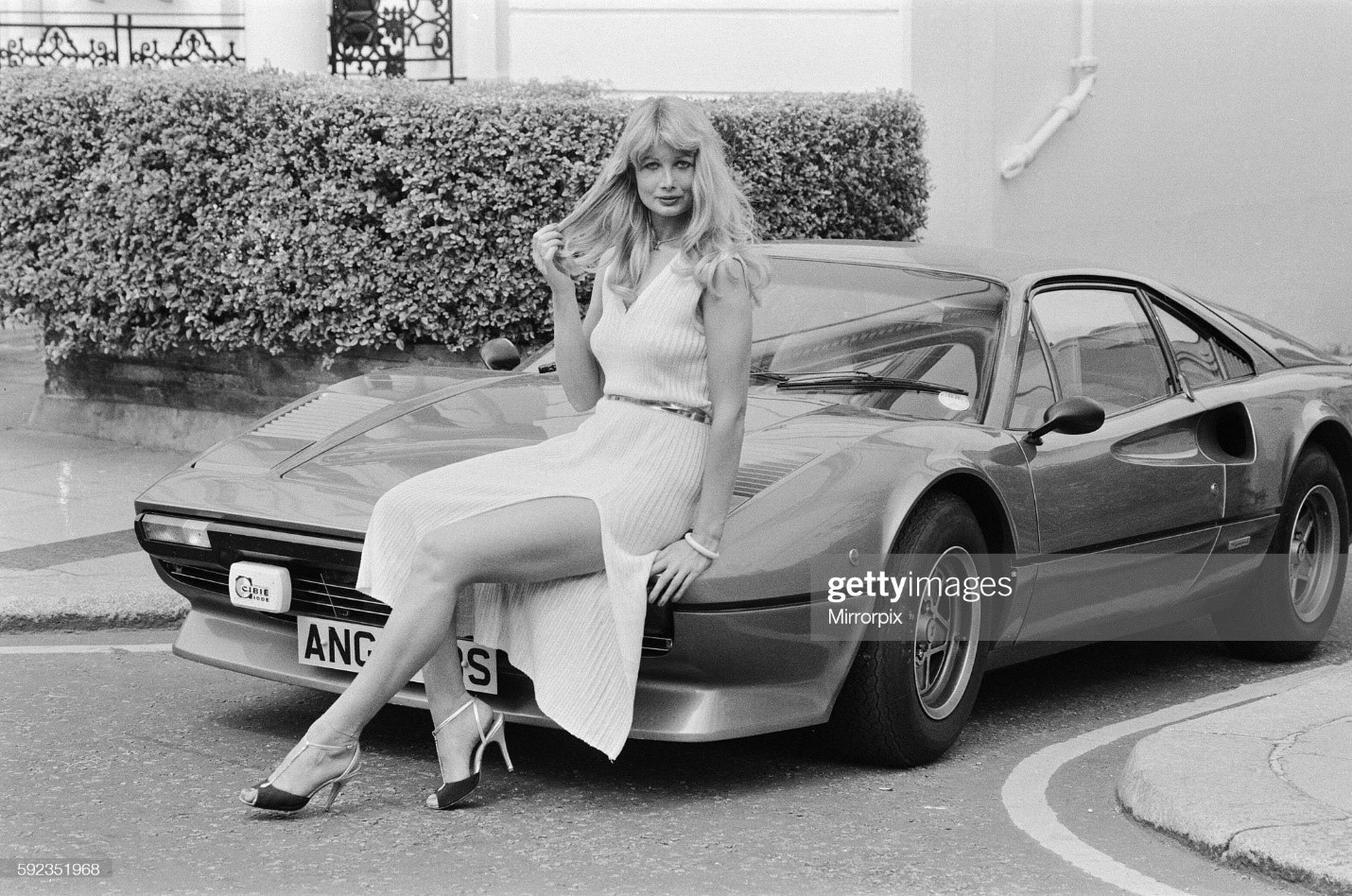 Glamour model Tina poses next to a Ferrari 308 GTB on 11 July 1979. 