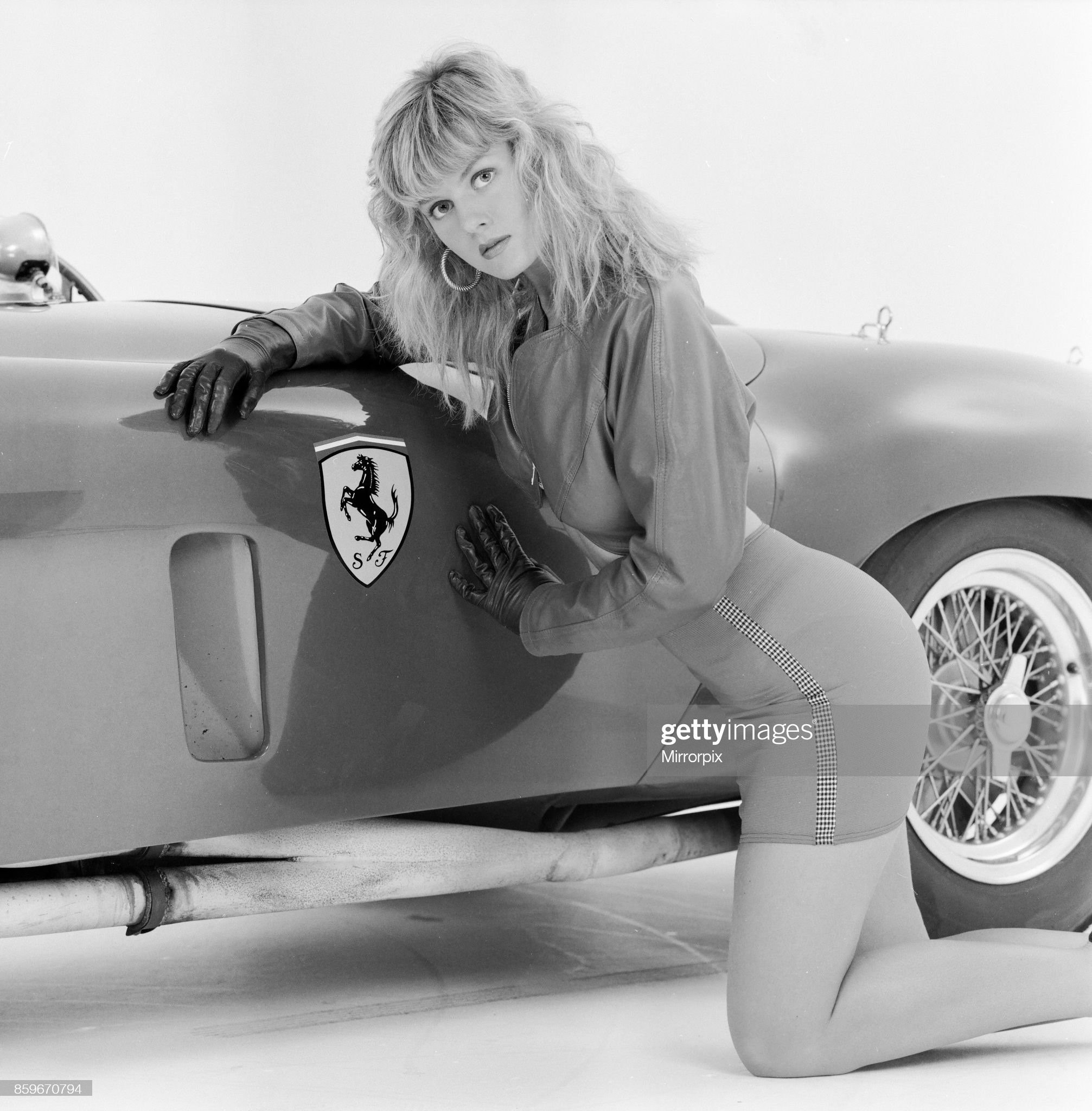 Glamour model Caroline Delahunty poses next to a Ferrari, 19th April 1988. 