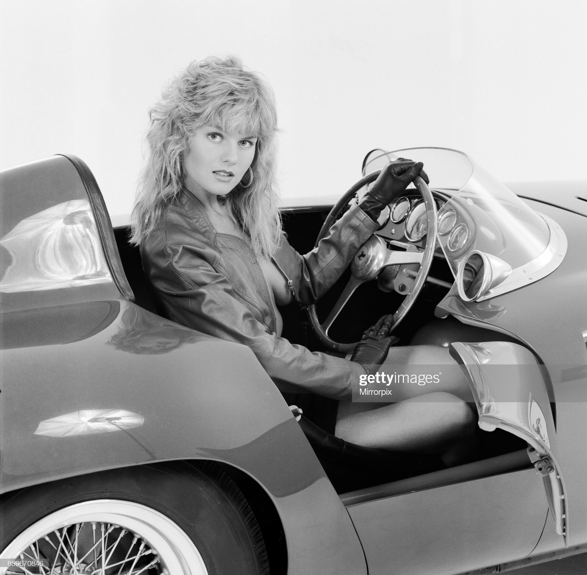 Glamour model Caroline Delahunty poses in a Ferrari, 19th April 1988. 