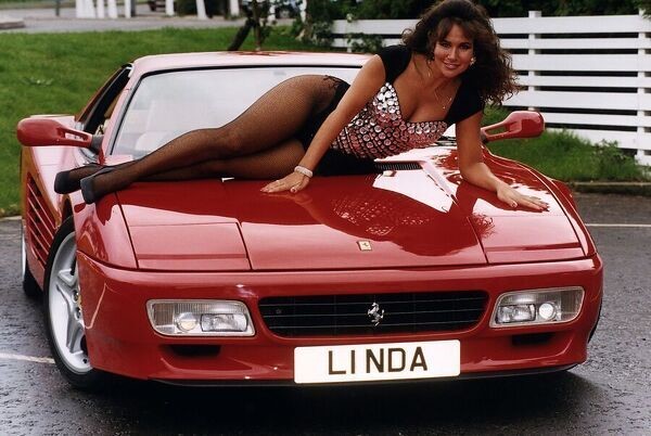 Lying on a Ferrari, Linda Lusardi poses with the number plate L1 NDA, which is to be auctioned at the DVLA classic collection sale, on October 01, 1993.