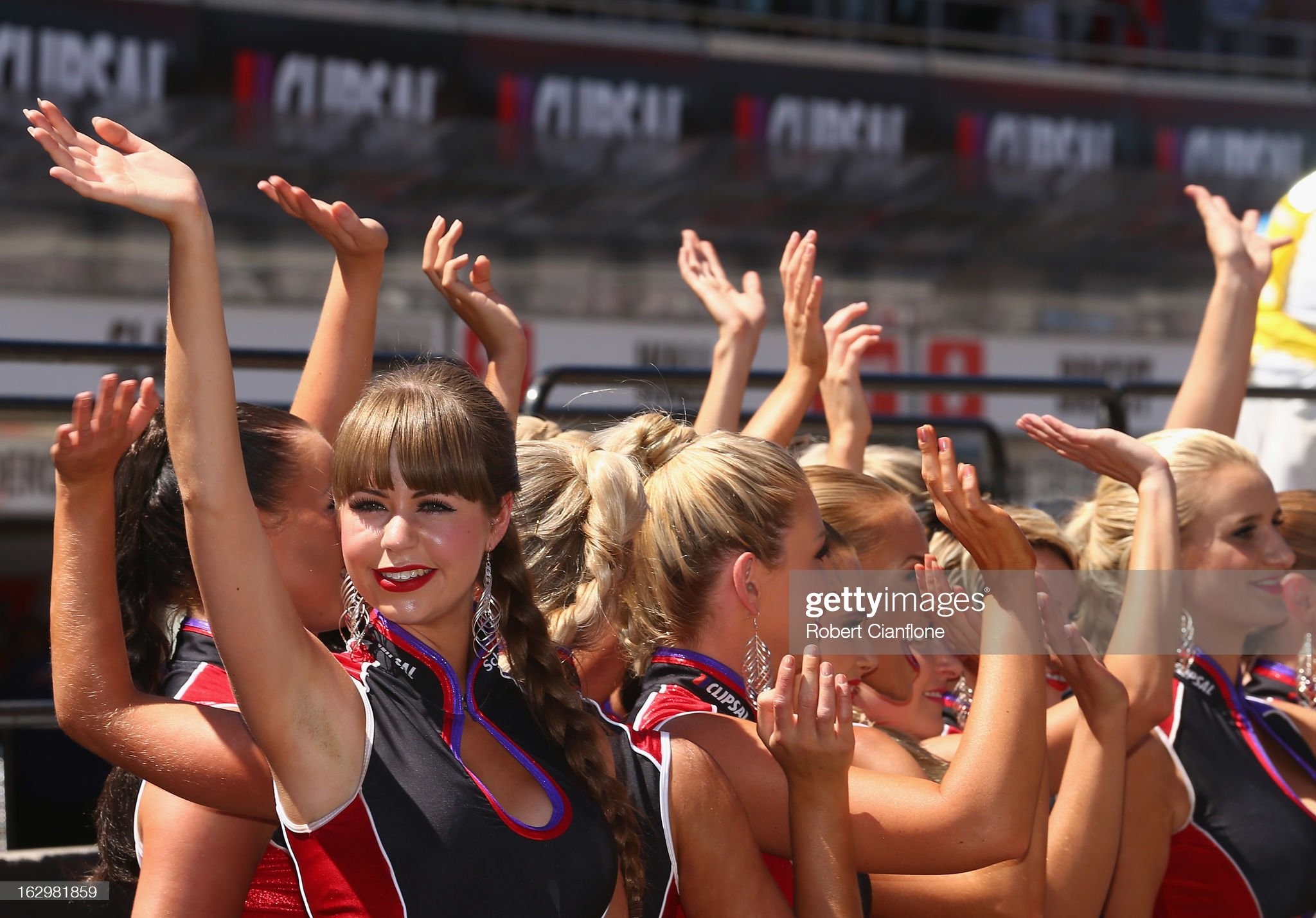 Grid girls wave to the crowd prior to race two of the Clipsal 500, which is round one of the V8 Supercar Championship Series, at the Adelaide Street Circuit on March 03, 2013 in Adelaide, Australia. 
