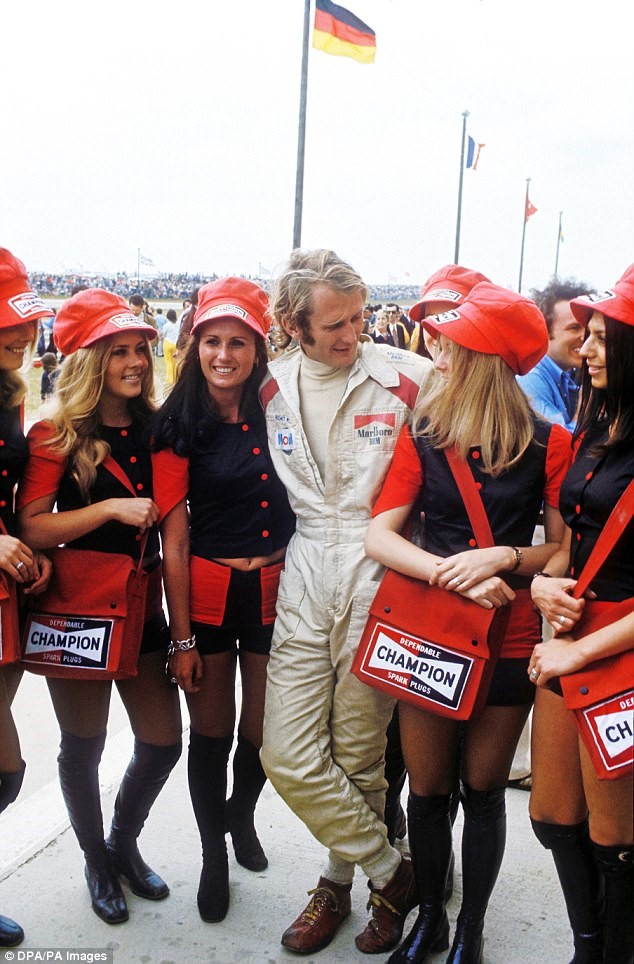 BRM driver Helmuth Marko with pit girls before the 1972 Belgian Grand Prix at Nivelles.