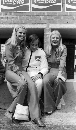 Jean Pierre Beltoise, BRM, is entertained by two Marlboro girls in the pits during practice. Belgian Grand Prix, Zolder,20 May 1973.