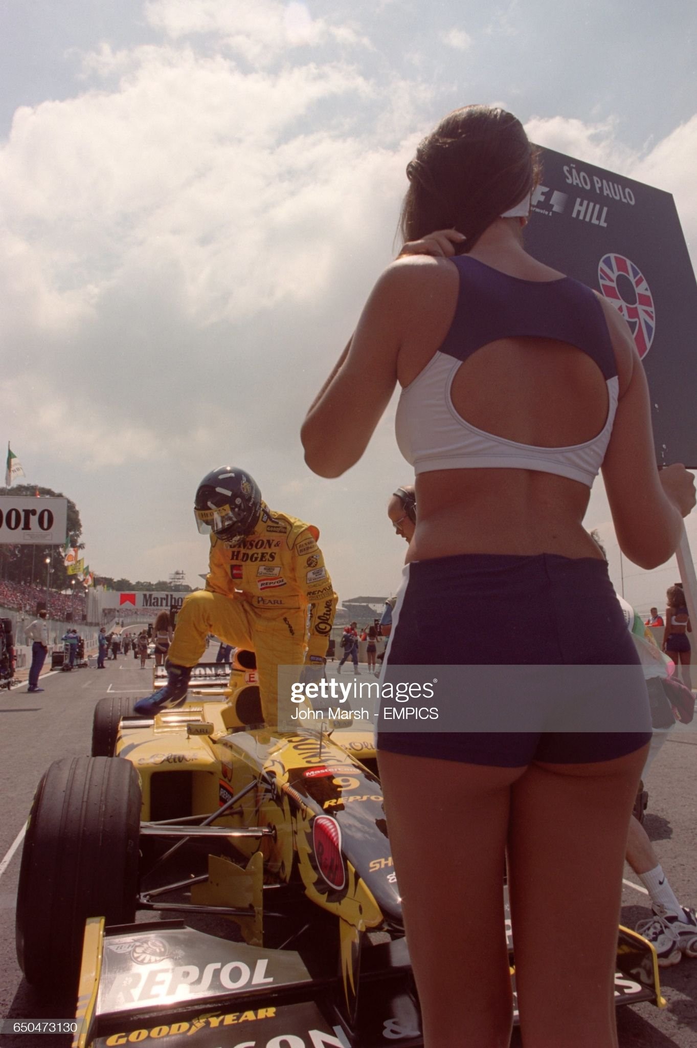Damon Hill on the grid with his grid girl at Interlagos, Brazil, on March 29, 1998. 