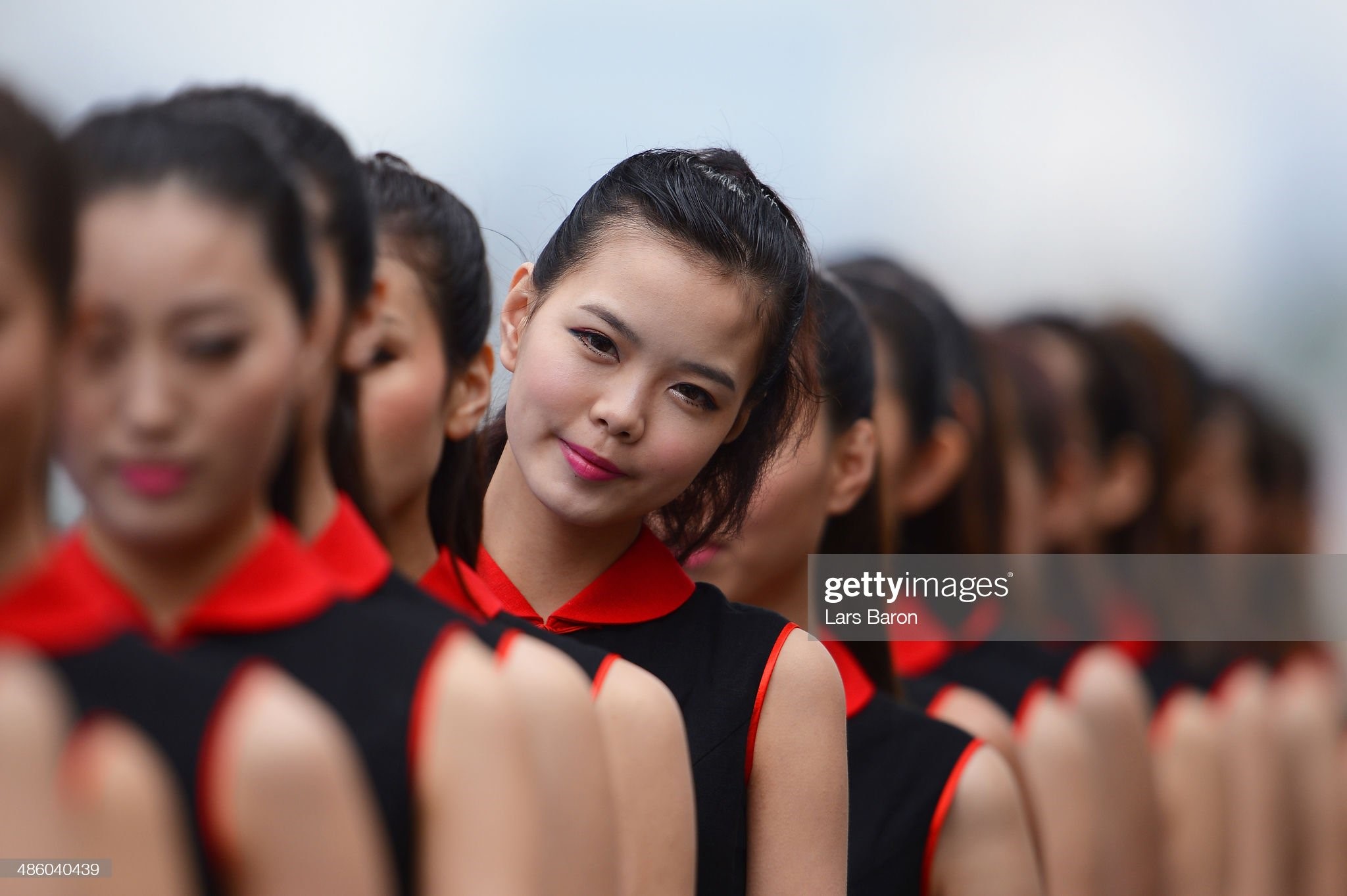 Grid girls are pictured prior to the Chinese Formula One Grand Prix at the Shanghai International Circuit on April 20, 2014 in Shanghai, China. 