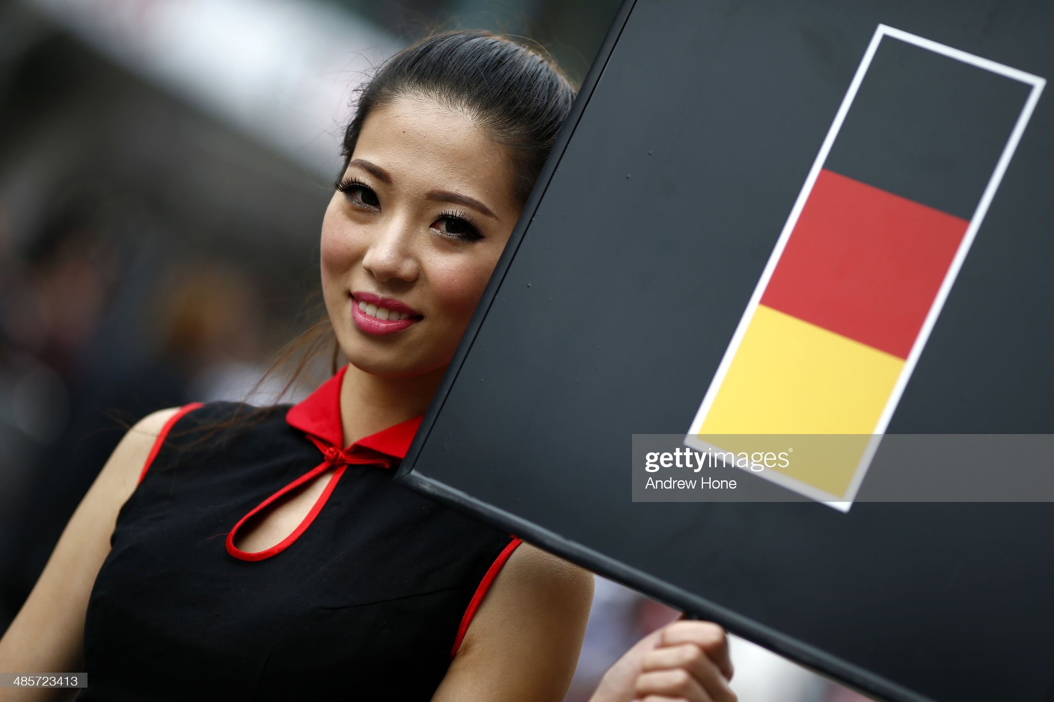 A grid girl holds up the board belonging to Sebastian Vettel of Germany and Infiniti Red Bull Racing during the Chinese Formula One Grand Prix at the Shanghai International Circuit on April 20, 2014 in Shanghai, China. 