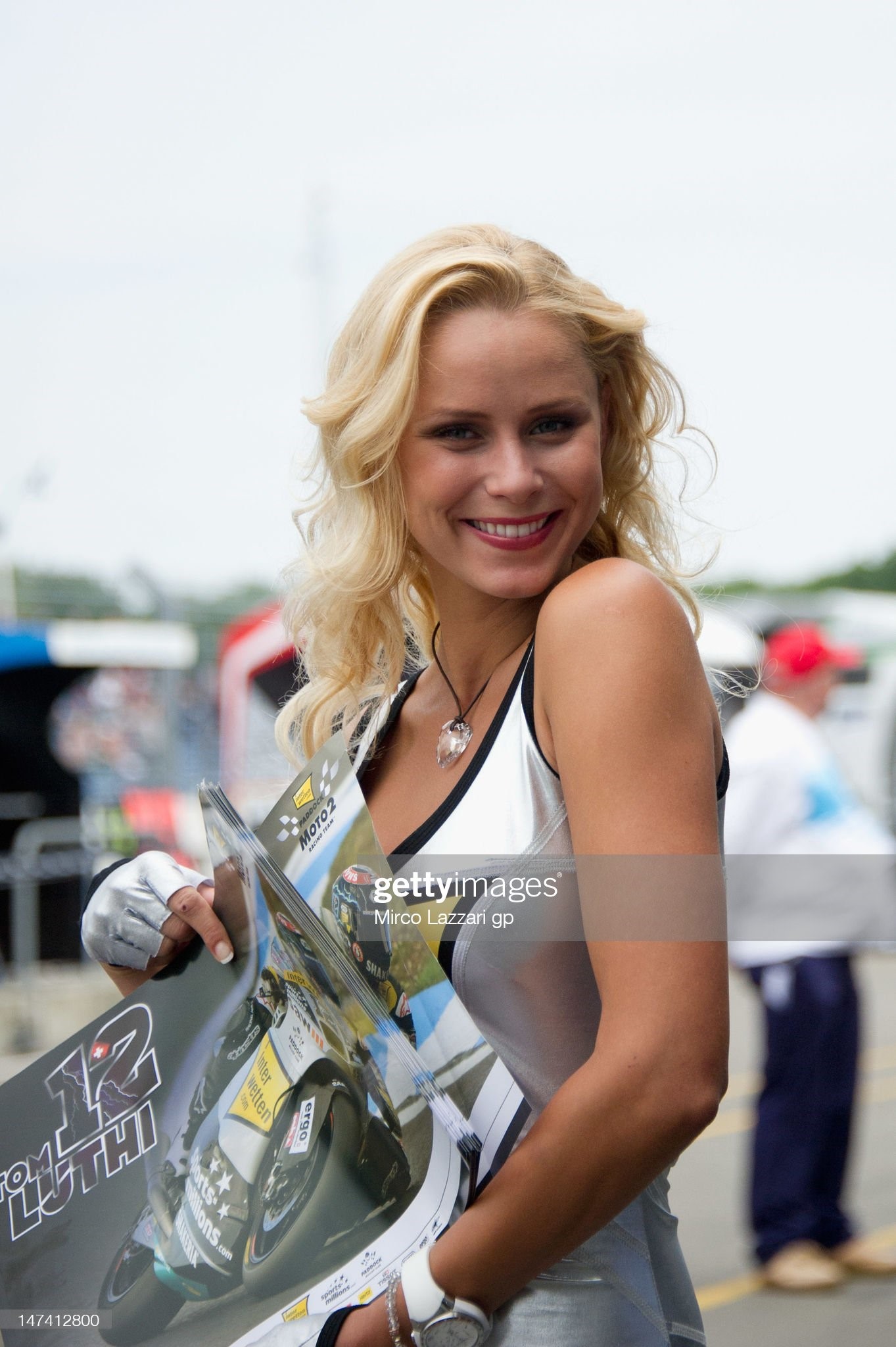 A grid girl poses and smiles at the pits during the qualifying practice of the MotoGp at TT Circuit Assen on June 29, 2012 in Assen, Netherlands. 