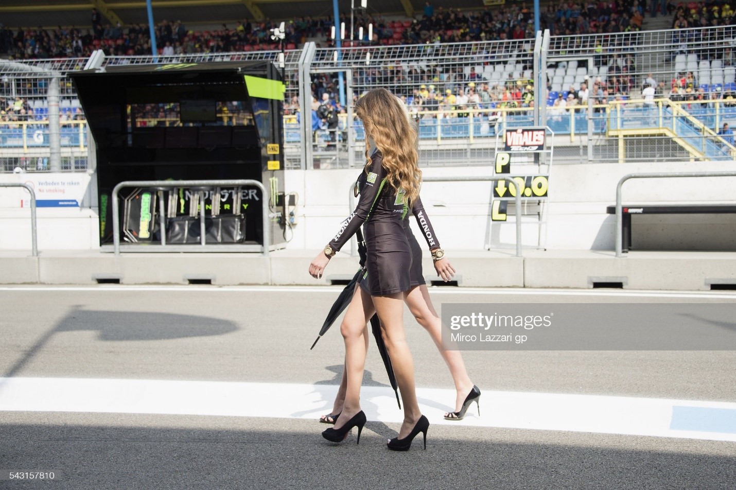 Grid girls walk in the pits before the Moto3 race during the MotoGP of the Netherlands on June 26, 2016 in Assen, Netherlands. 