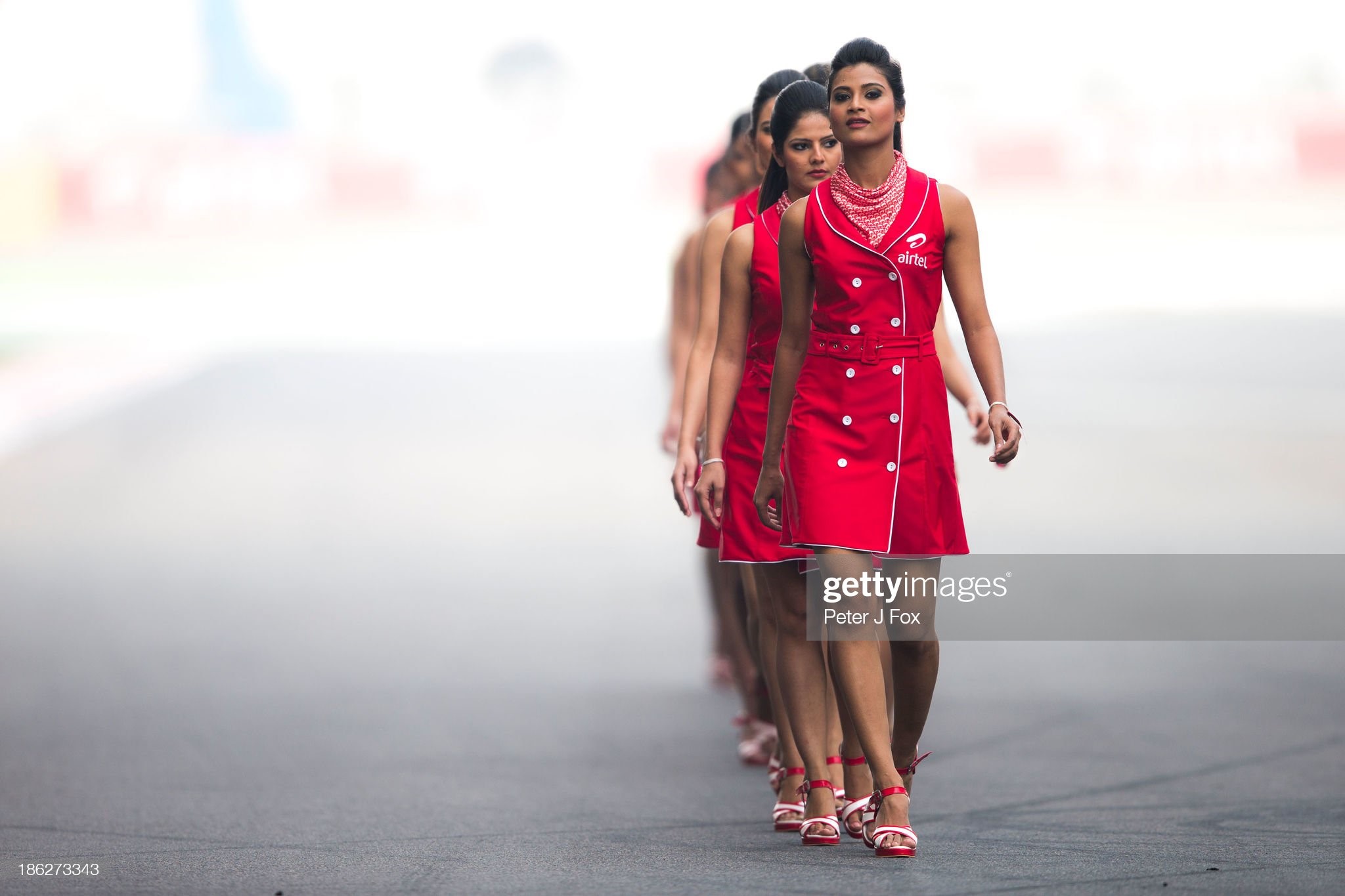 Grid girls walk on the tarmac during the Indian Formula One Grand Prix at Buddh International Circuit on October 27, 2013 in Noida, India. 