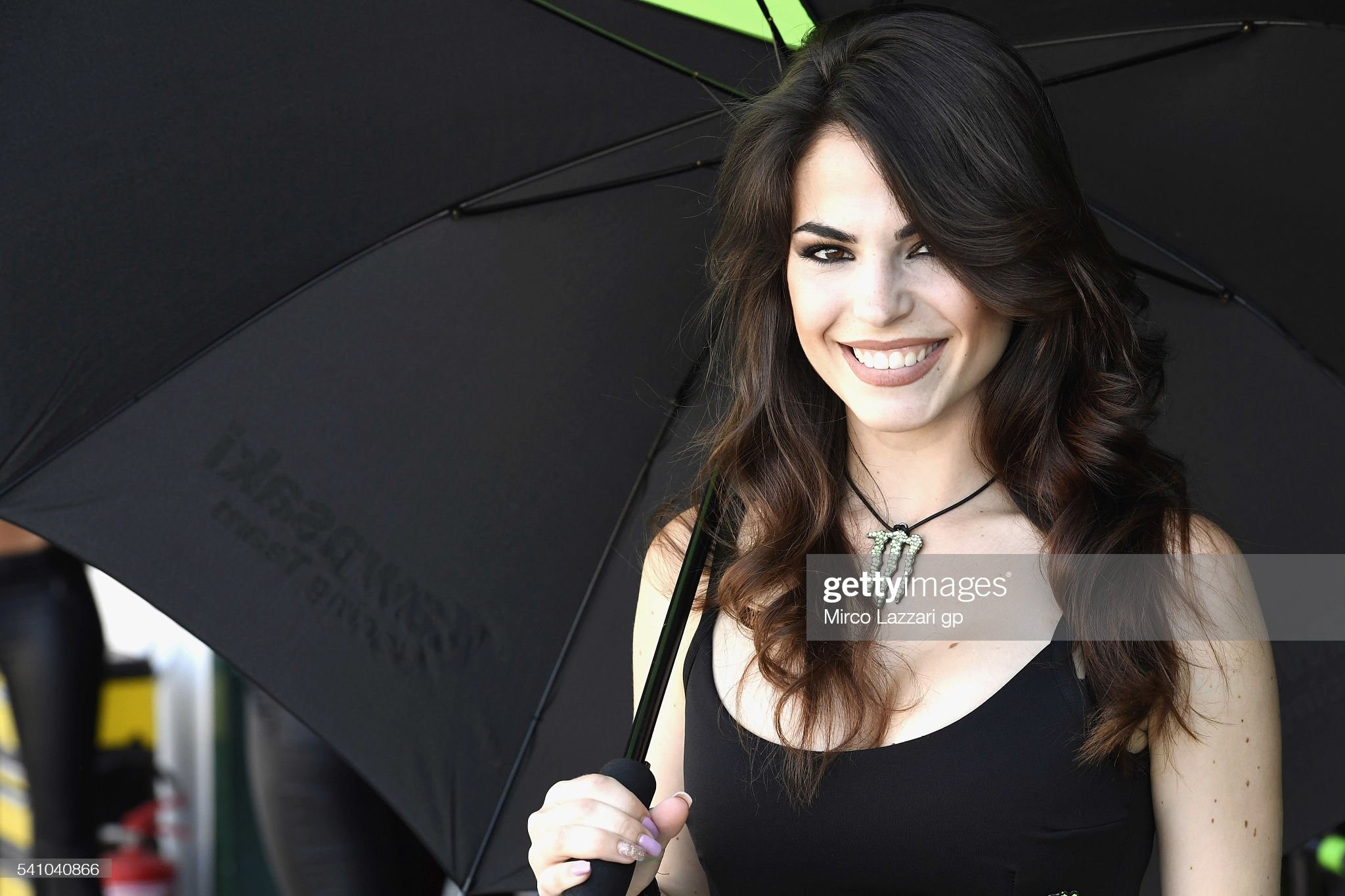 A grid girl smiles in the pits before the race 1 during the FIM Superbike World Championship qualifying at Misano World Circuit on June 18, 2016 in Misano Adriatico, Italy. 