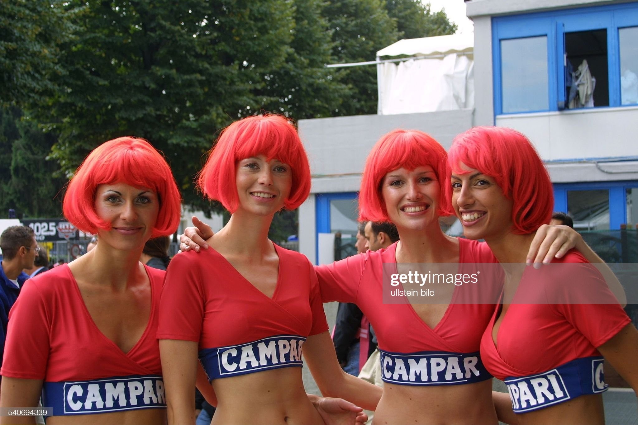Formula 1 Grand Prix of Italy in Monza: grid girls dressed in red, sexy, skin-tight cropped jerseys, with wigs and Campari advertising on September 16, 2001. 