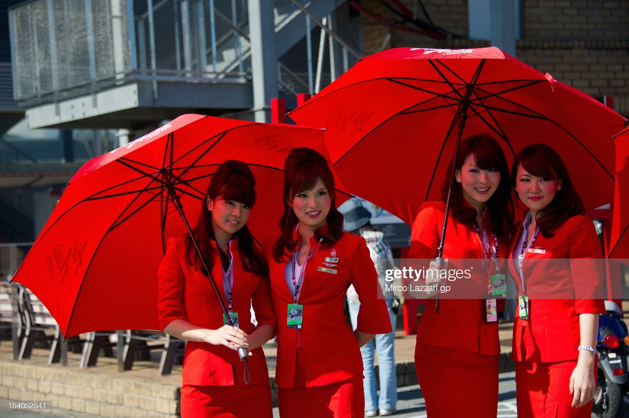 The grid girls pose in paddock during the qualifying practice of the MotoGP of Japan at Twin Ring Motegi on October 13, 2012 in Motegi, Japan. 