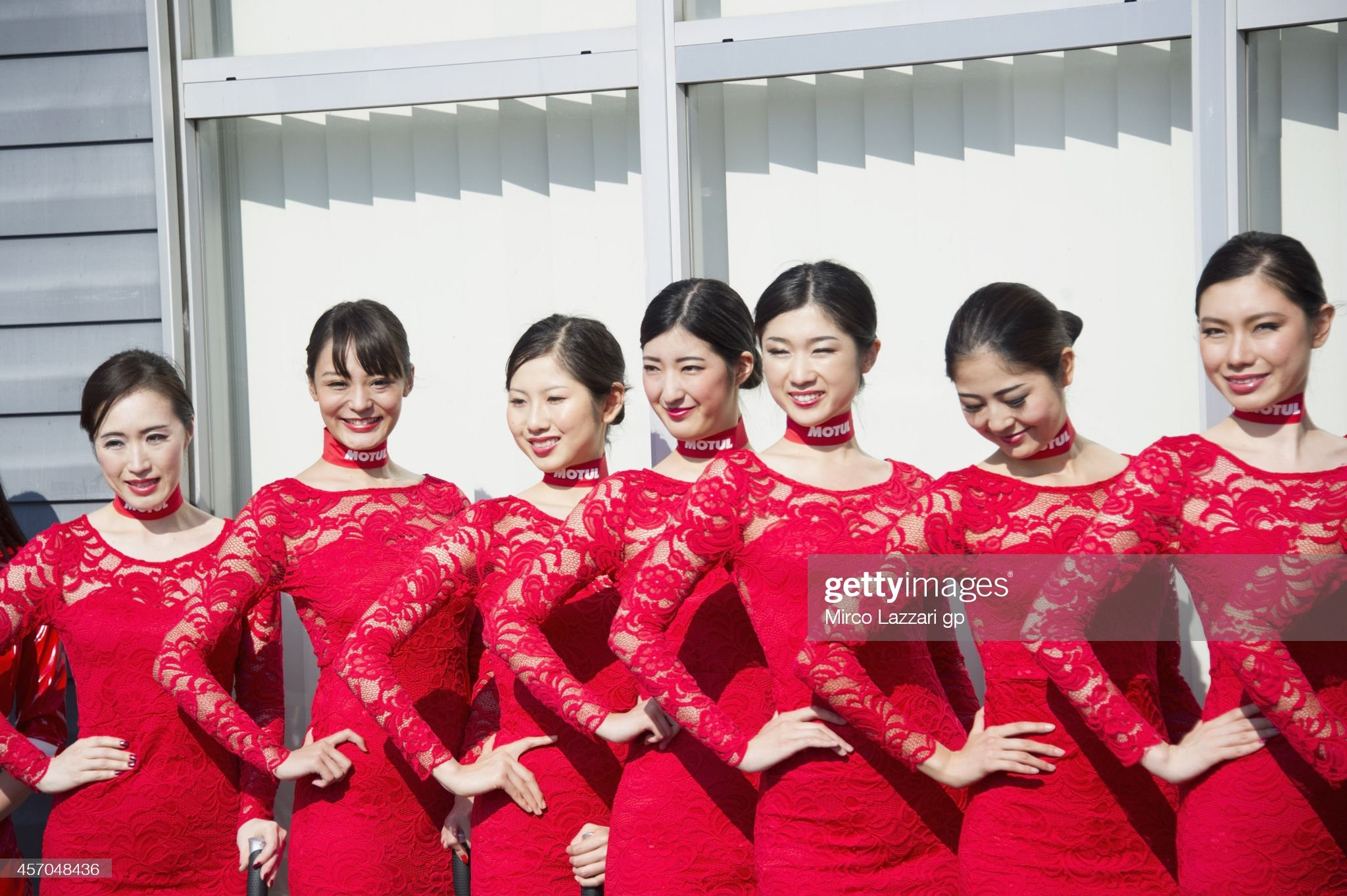 The grid girls pose in paddock during the qualifying of the MotoGP of Japan at Twin Ring Motegi on October 11, 2014 in Motegi, Japan. 