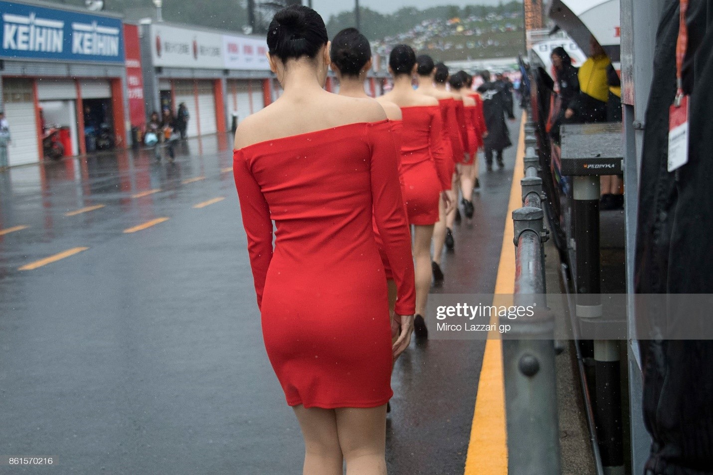 The grid girls walk in the pits during the Moto2 race during the MotoGP of Japan at Twin Ring Motegi on October 15, 2017 in Motegi, Japan. 