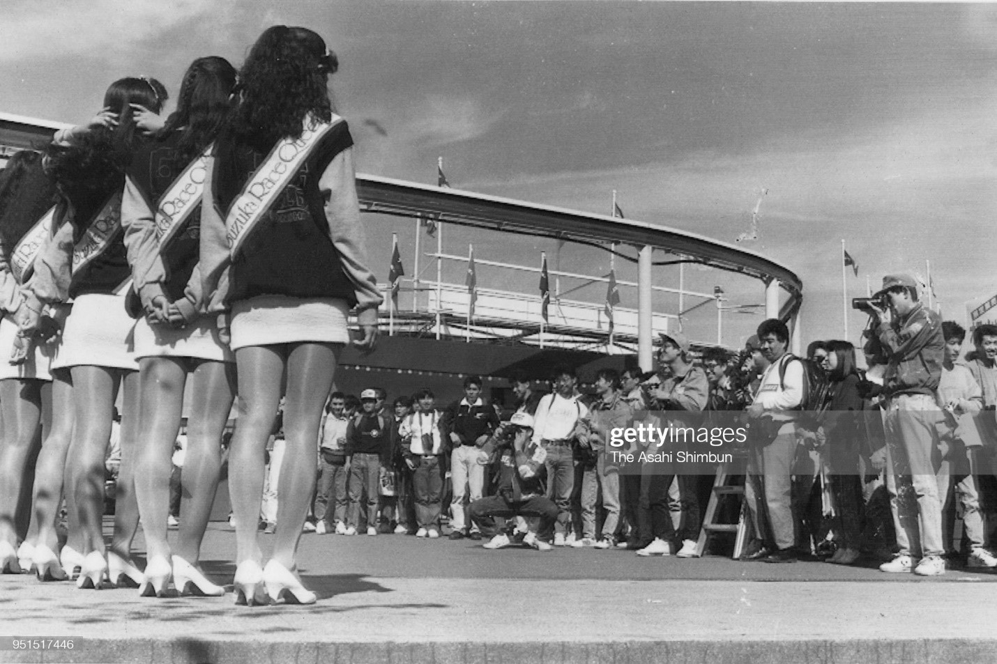 Grid girls pose for photographs during the qualifying of F1 Japanese Grand Prix at Suzuka Circuit on October 19, 1990 in Suzuka, Mie, Japan. 