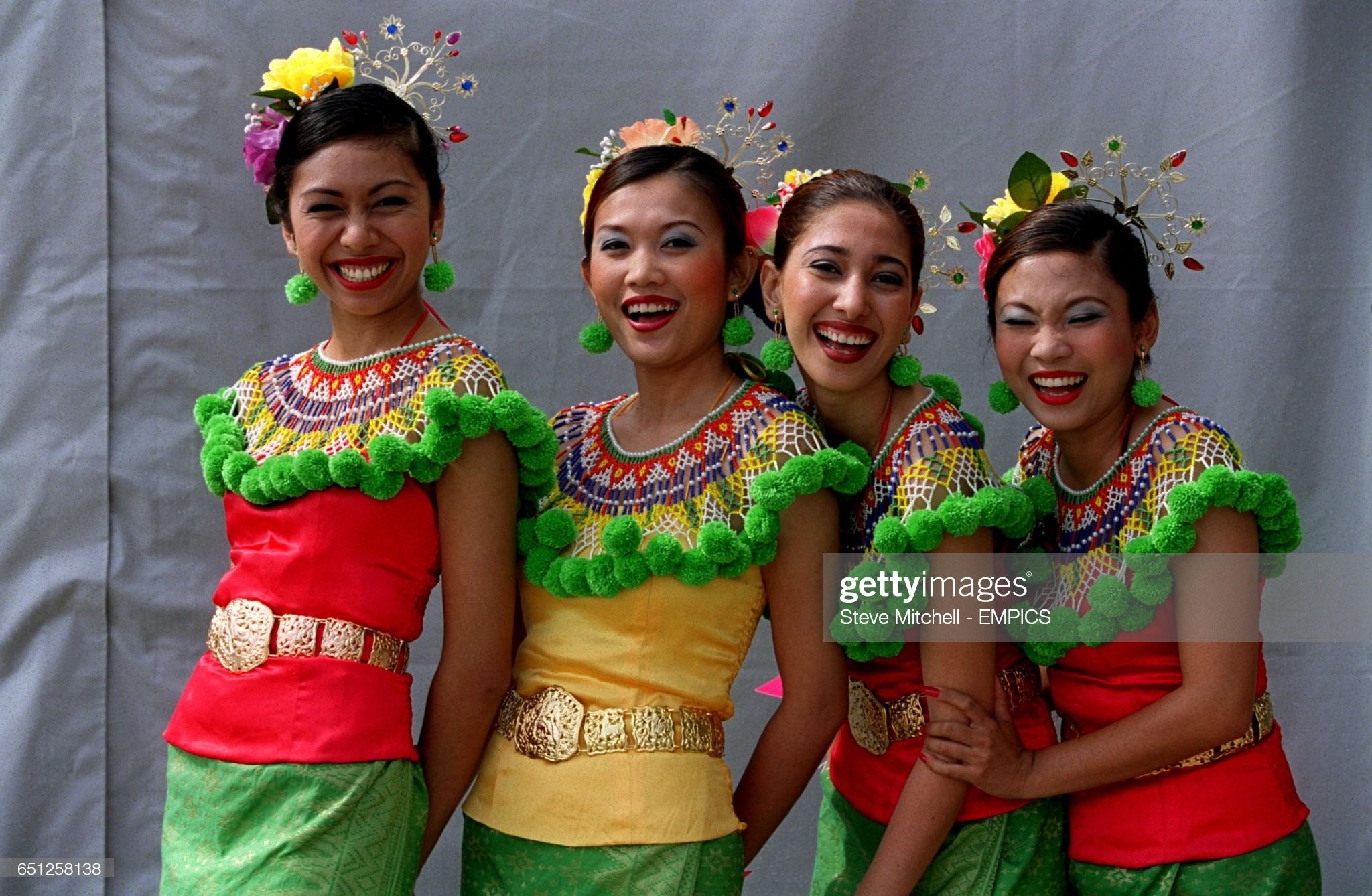 Grid girls get the giggles before the Malaysian Grand Prix on March 18, 2001. 