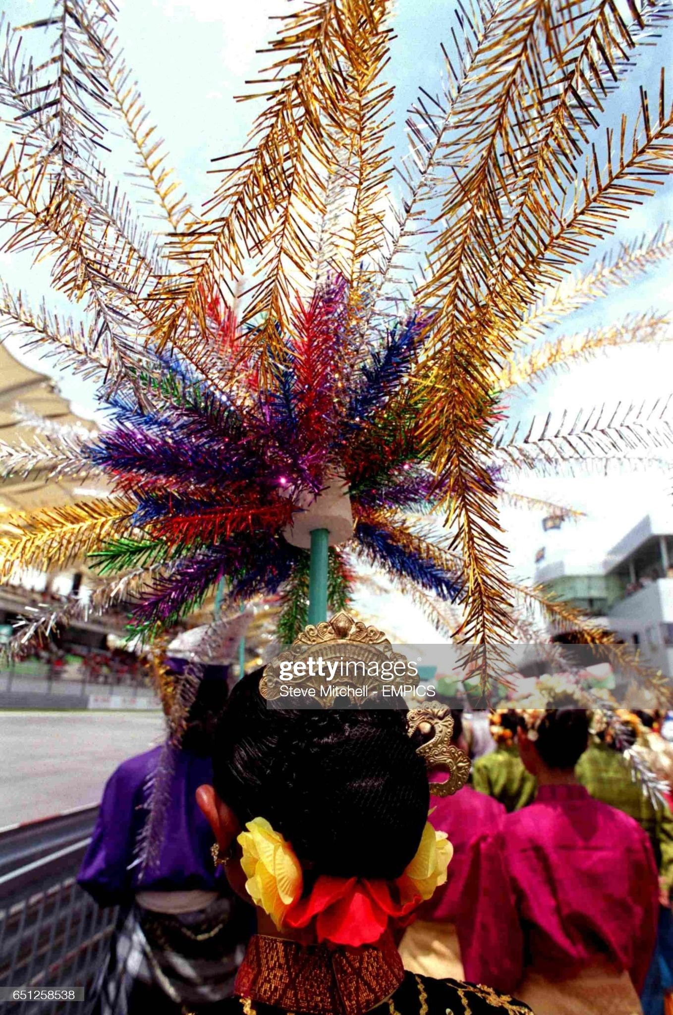 A grid girl wearing a traditional Malaysian headdress on March 18, 2001. 