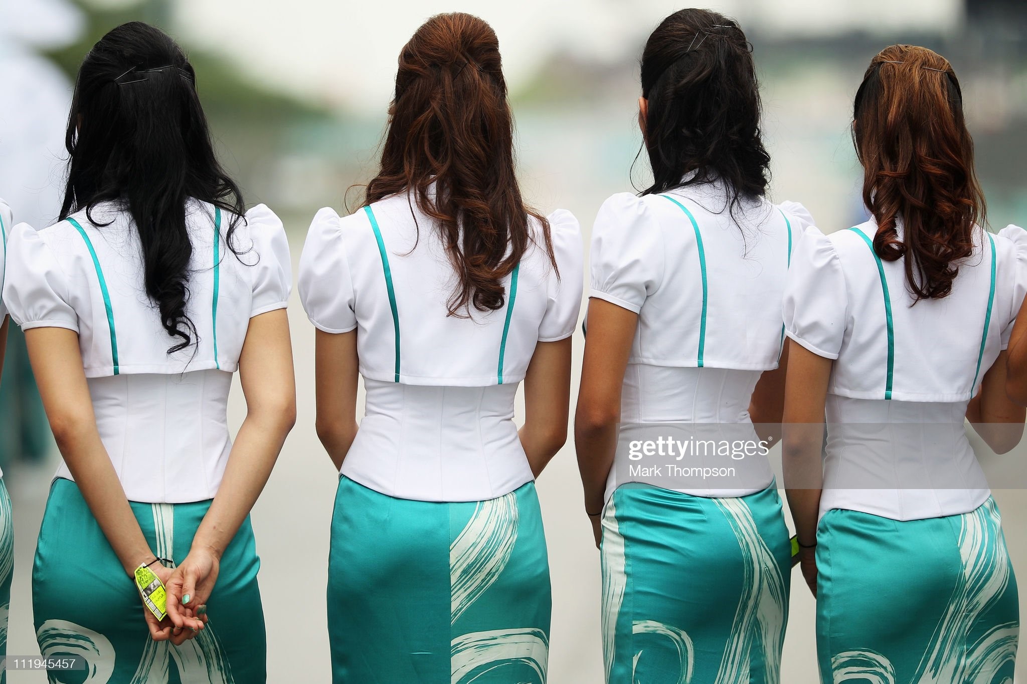 Grid girls are seen before the start of the Malaysian Formula One Grand Prix at the Sepang Circuit on April 10, 2011 in Kuala Lumpur, Malaysia. 