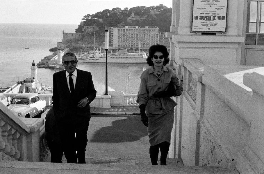 1959, Monaco, Aristotle Onassis and Maria Callas ascend steps on the eastern side of the harbor while the MV Christina rests at anchor in the background.