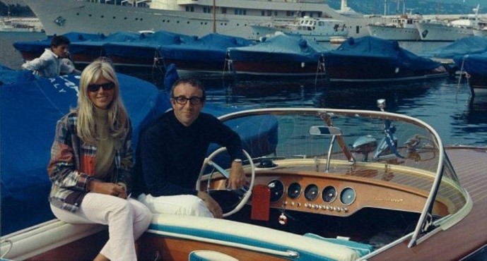 Monaco harbor, 1966, Peter Sellers in his Riva Ariston with Britt Ekland. The MV Christina O, the yacht of Aristotle Onassis, rests at anchor in the background.