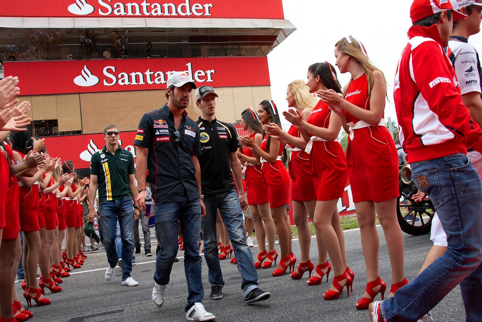Romain Grosjean, Jean Eric Vergne and grid girls at Barcelona, Spain, in 2012.