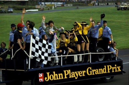 Jody Scheckter, Tyrrell 007, celebrates victory on the JPS mobile podium with his wife Pam, South Africa, members of the Tyrrell team and the JPS grid girls. British Grand Prix, Brands Hatch, 20 July 1974. 