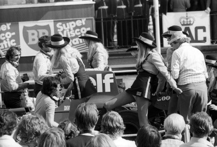 The JPS grid girls climb onto the Tyrrell 007 of race winner Jody Scheckter after the race. Brands Hatch, England, 20 July 1974.
