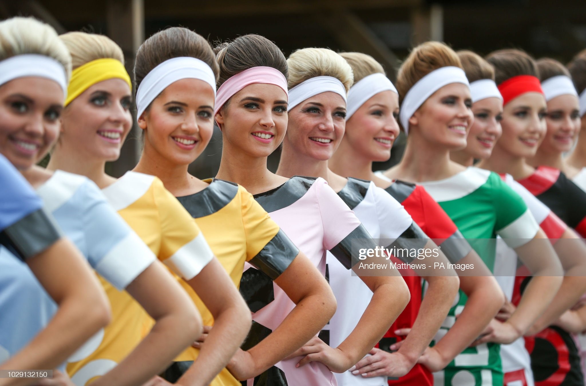 Grid girls pose for a photograph in the paddock on day two of the Goodwood Revival at the Goodwood Motor Circuit, in Chichester on September 08, 2018. 