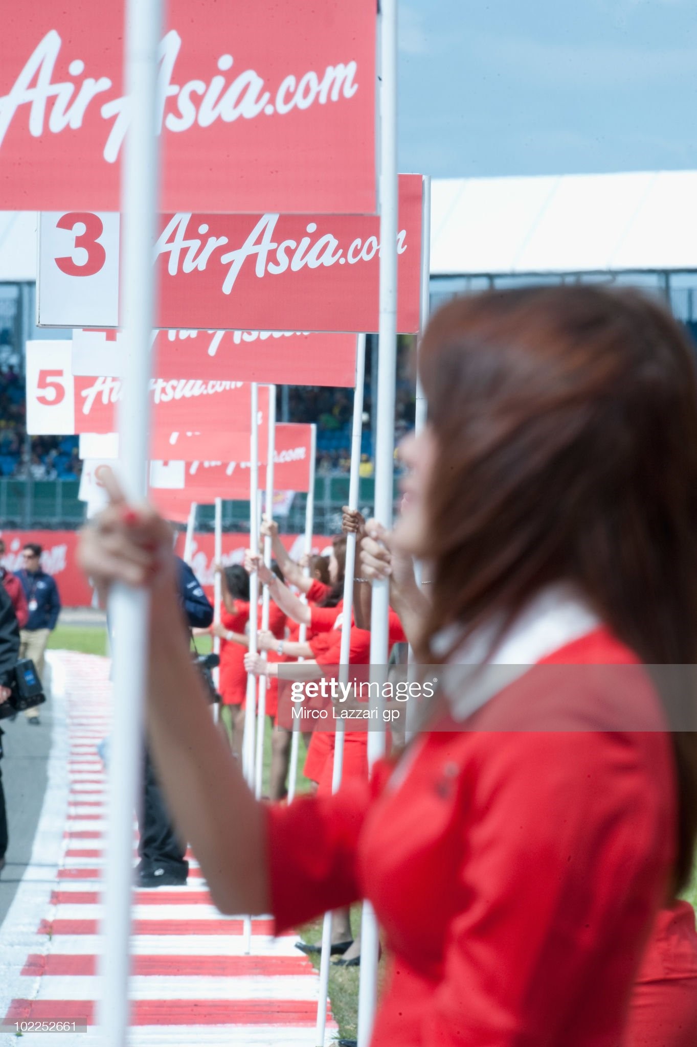 The girls pose on the grid and sign the rows before the MotoGP race of British Grand Prix at Silverstone Circuit on June 20, 2010 in Northampton, England. 