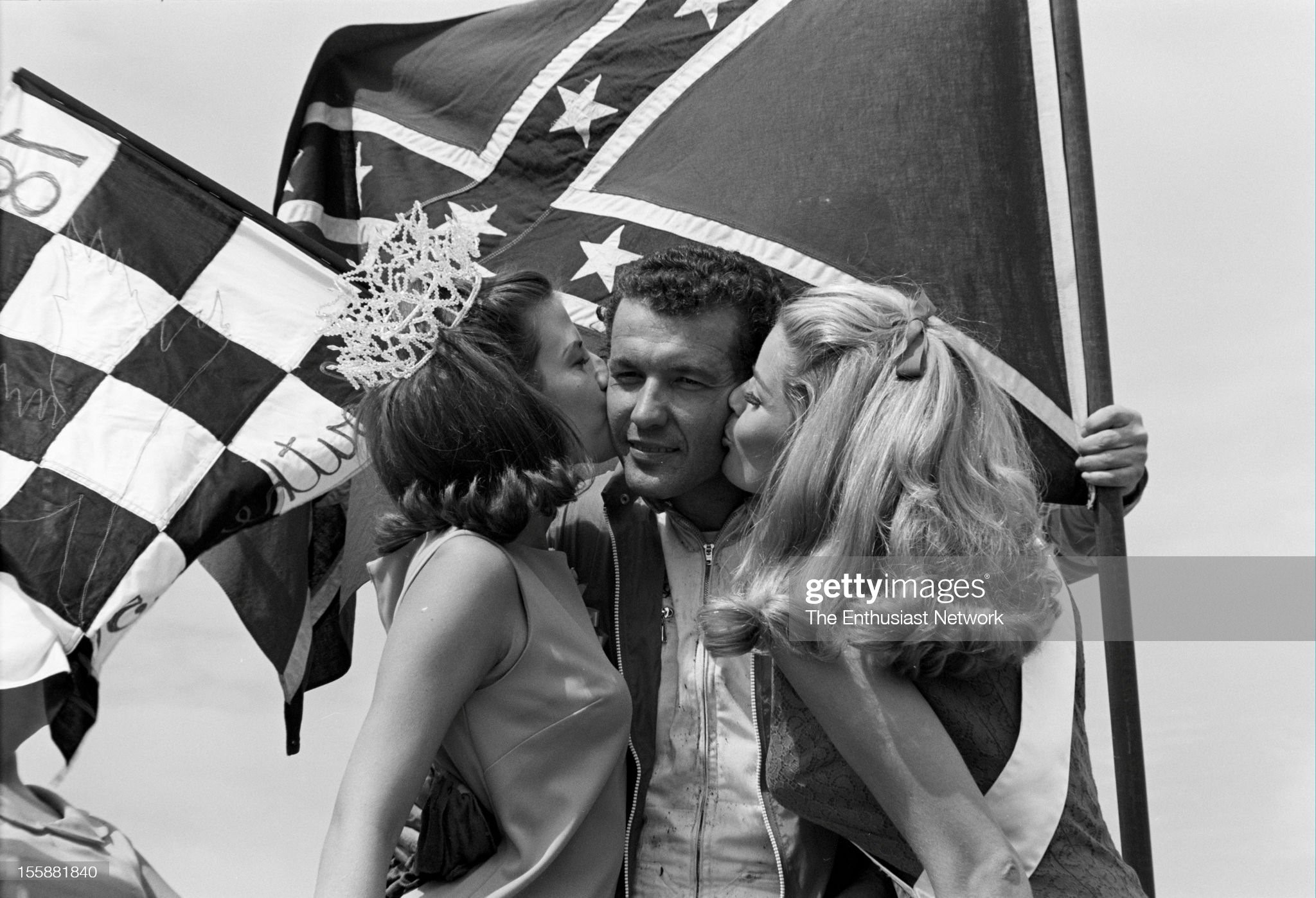 United States, September 06, 1967, Darlington Southern 500. Race winner Richard Petty celebrates his victory on the podium with race queen and miss Firebird. 