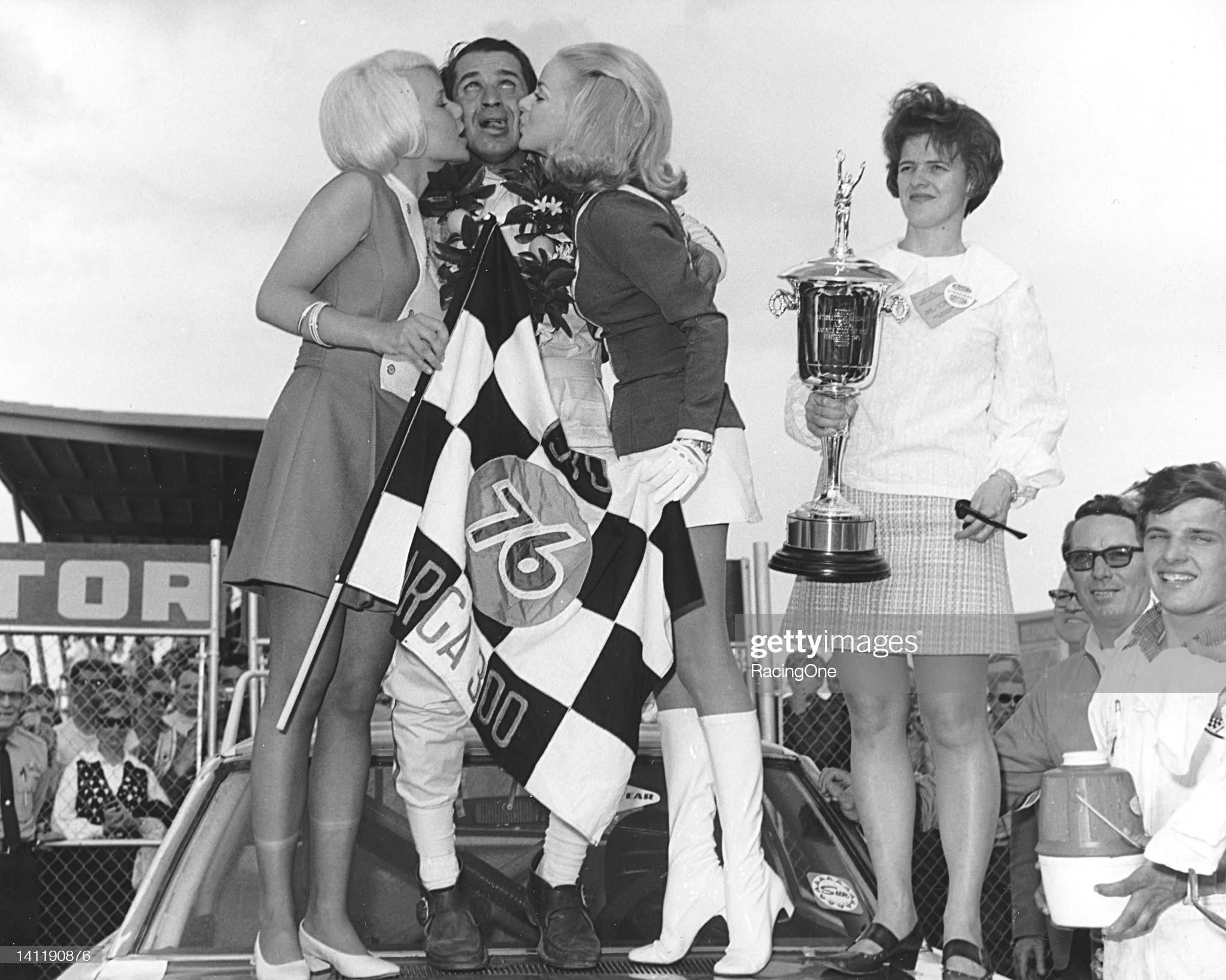 Daytona Beach, Florida, February 15, 1970: Ramo Stott reacts to a double-whammy of kisses from the race queens after winning the ARCA 300 at Daytona International Speedway.