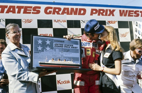 F1 USA West GP, Long Beach, March 28 1976. Clay Regazzoni celebrates victory on the podium.