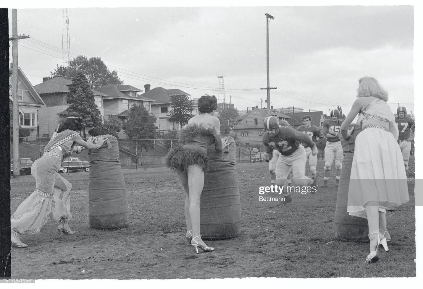 Tackling practice definitely picked up in enjoyment on October 04, 1954 when three local show girls paid a visit to a drill session of the Seattle Ramblers grid club. The girls, Vickie, Marvan and Zabuda (left to right), drew an enthusiastic response from the tacklers, who wanted to keep up the practice all day.