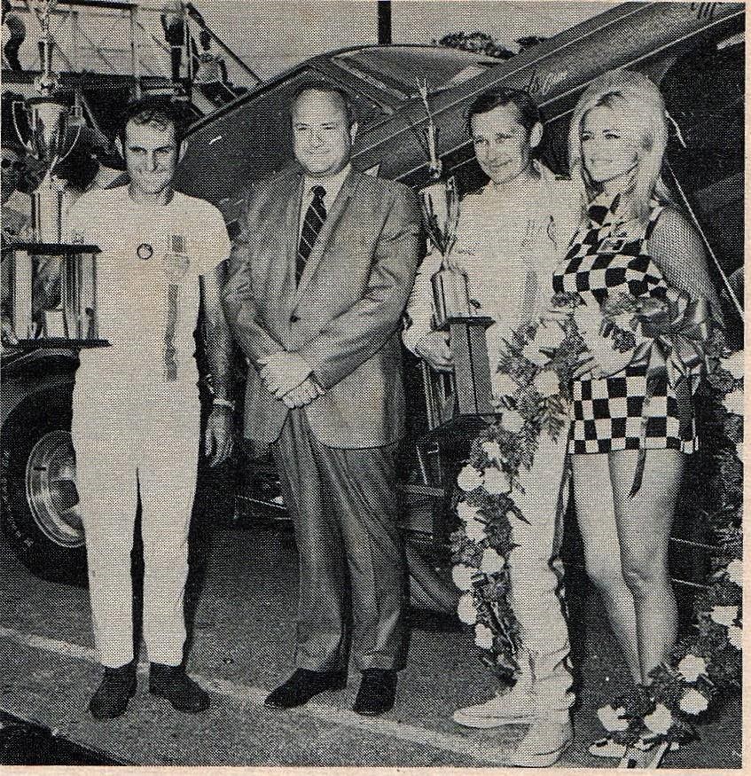 Two vintage drivers, a girl and a car.