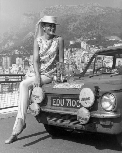 A vintage girl on a car.