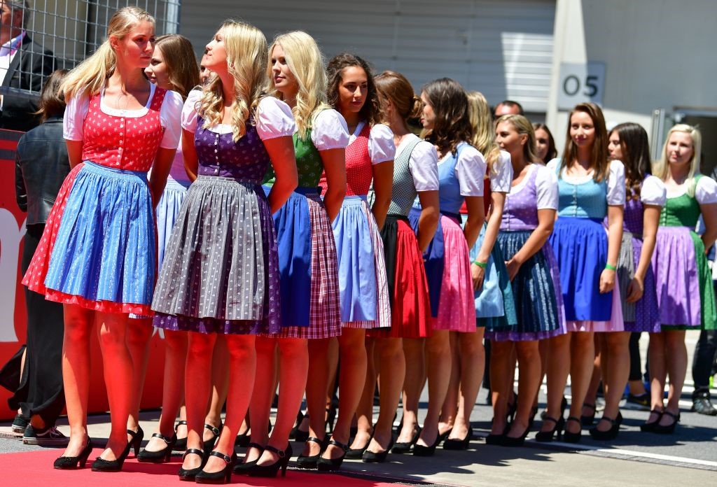 Ladies wearing traditional Dirndl dresses get ready before the start of the Austrian Formula One Grand Prix in Spielberg.
