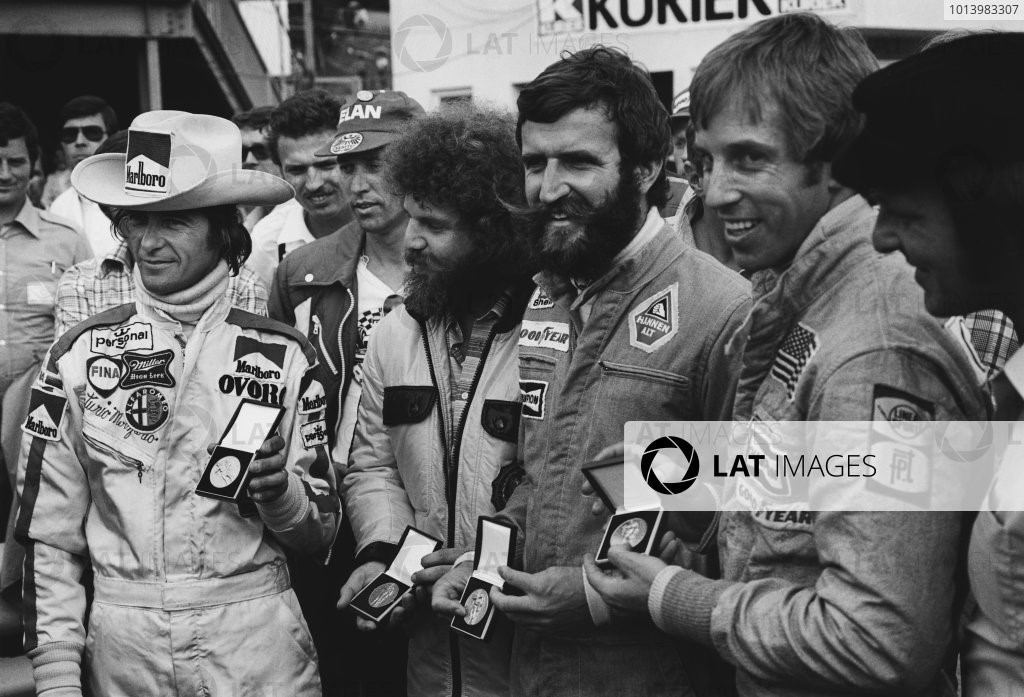 1976 Austrian Grand Prix. Osterreichring, Zeltweg, Austria. 13th - 15th August 1976. Arturo Merzario, a representative of Guy Edwards, Harald Ertl and Brett Lunger receive medals for saving Niki Lauda from his near fate.