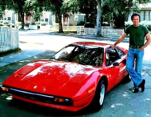 Clint Eastwood posing with a fresh-off-the-line Ferrari 308 GTB, in 1978.