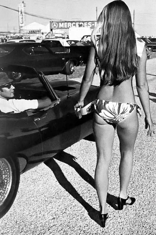 A vintage girl and a black Jaguar E-type.