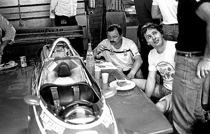 Gilles Villeneuve and his mechanics having a lunch break on a Ferrari 126C2.
